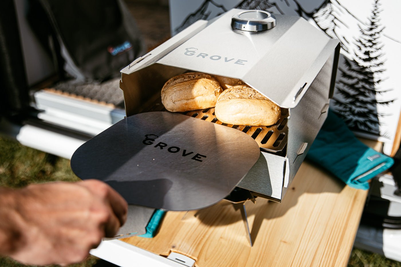 Ambientefoto:
Horst der multifunktionale Campingofen mit Brötchen auf dem Pizzaschieber im Backofen